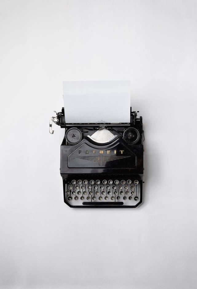 typewriter with blank paper