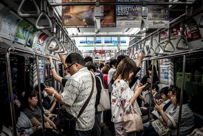 people on phone on the subway