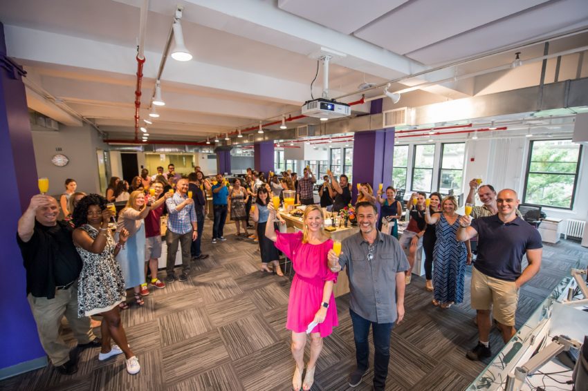 first agency team raising a glass celebration